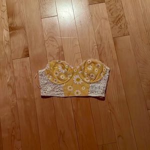 selling a crop top, yellow with flowers, size is small